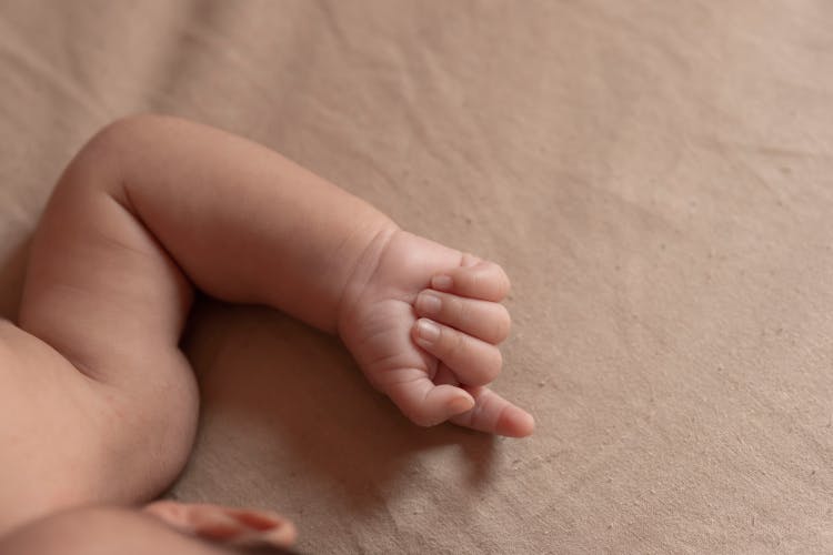 Hand And Arm Of Baby Lying Down