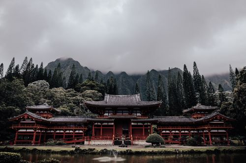 Free Byodo-In Temple surrounded by lush forest in Hawaii offers serene beauty. Stock Photo