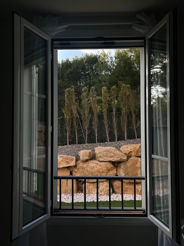 Opened Window And Stones In Yard