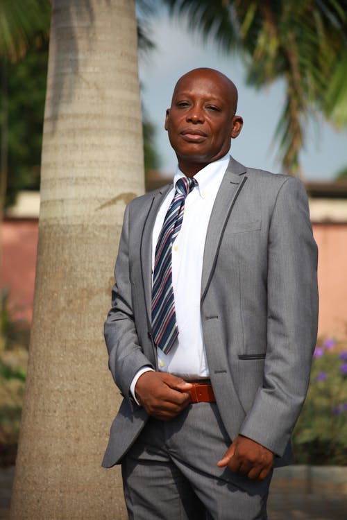 Man in a Suit Standing Outdoors 