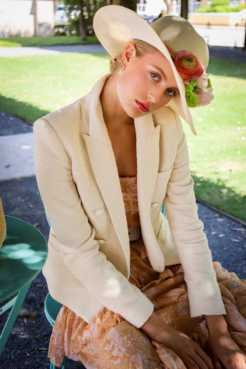Woman Sitting in Garden Wearing Hat