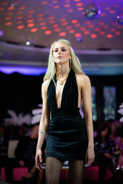 Young Woman in a Black Dress on a Fashion Show 