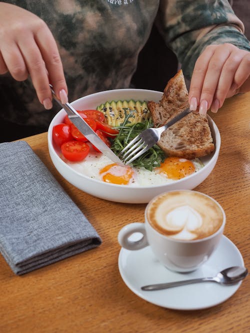 Woman Eating a Salad with Eggs