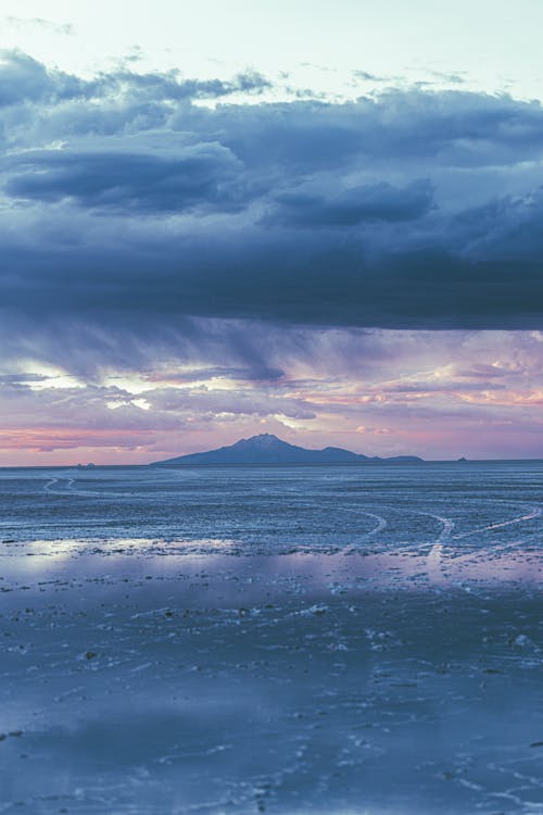 Foto profissional grátis de céu com cores intensas, clima, litoral