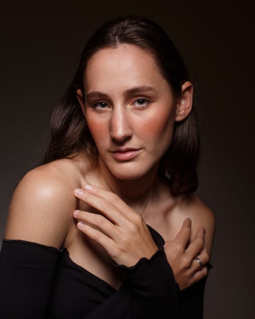 Portrait of Young Woman Posing in Black Studio