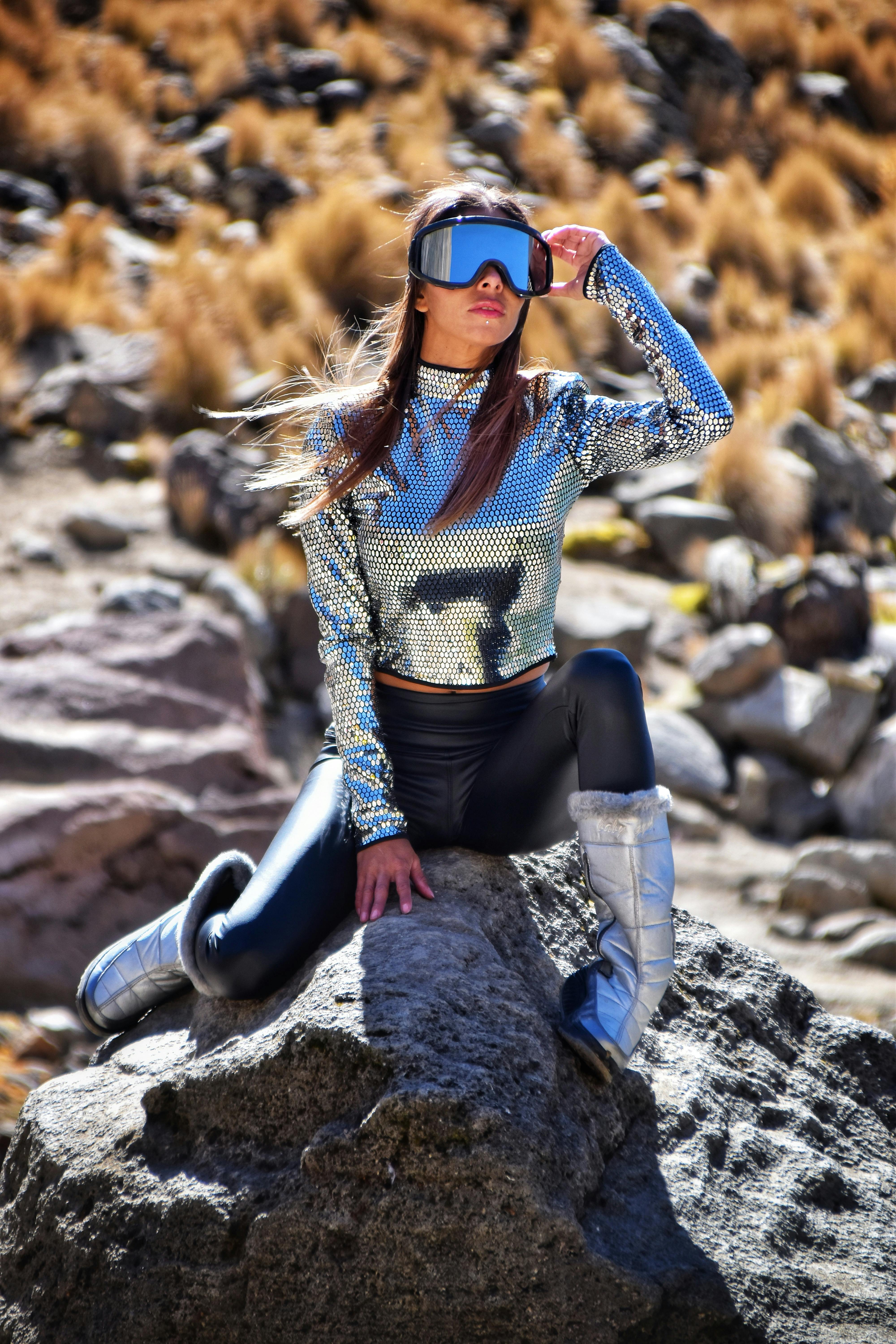 Prescription Goggle Inserts - Model posing outdoors in a glittery silver outfit and ski goggles for a futuristic fashion shoot.