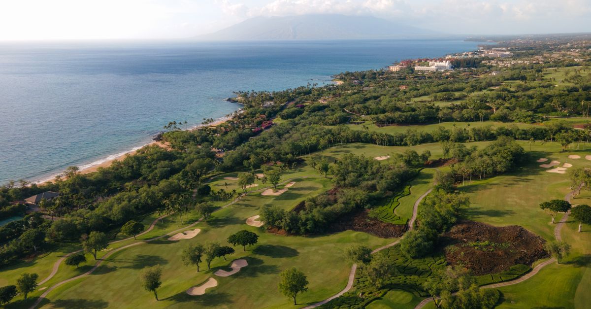 Photo by Griffin Wooldridge A breathtaking aerial view of a lush golf course by the scenic coastline in Wailea-Makena, Hawaii.