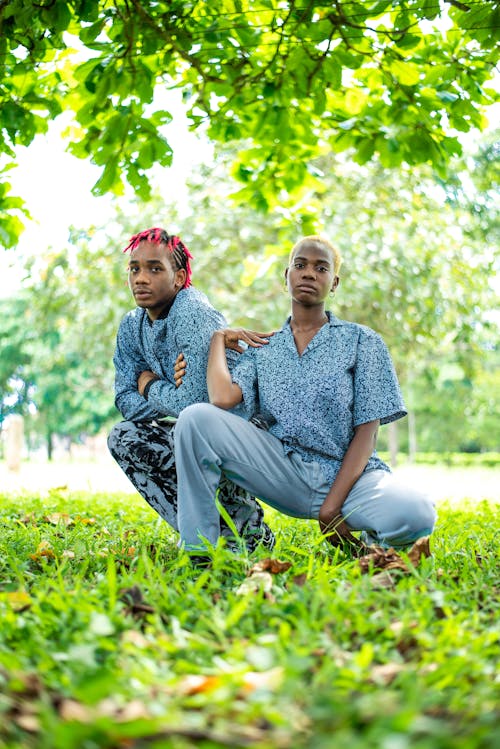 Woman and Man Crouching in Same Shirts