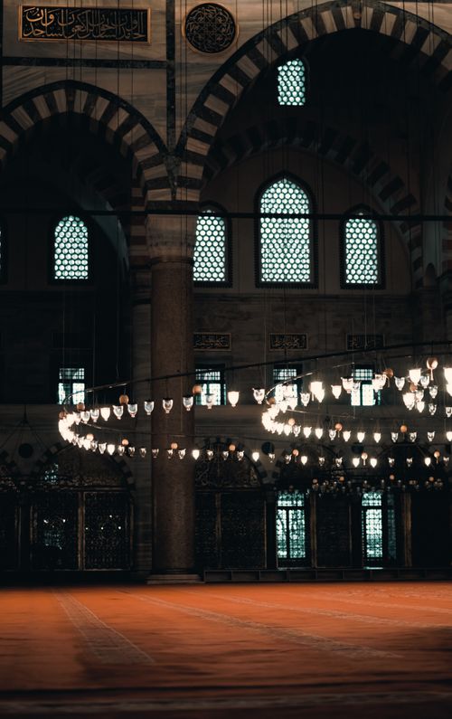 Free Stunning interior of a historic mosque with ornate chandeliers and architectural details. Stock Photo