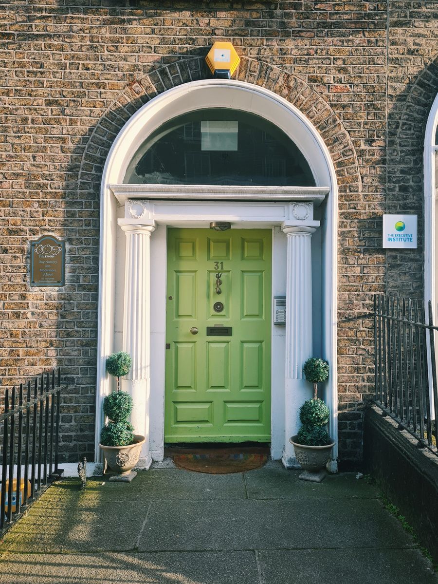 A green Georgian door with a fanlight in Dublin