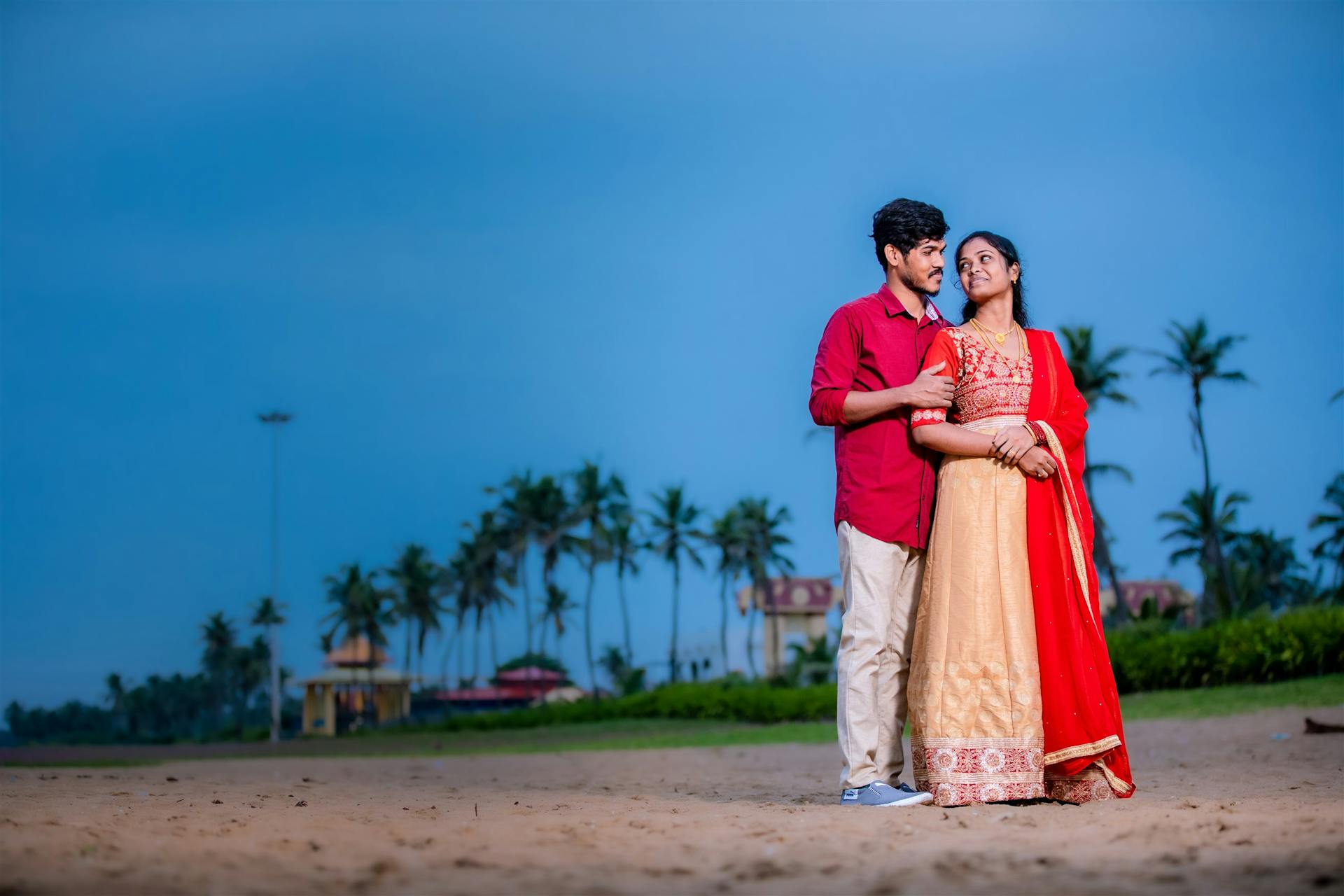 A happy couple embracing on a Chennai beach at sunset, symbolizing love and togetherness.