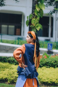 Stylish woman posing outdoors in Bandung, Indonesia with vibrant outfit.