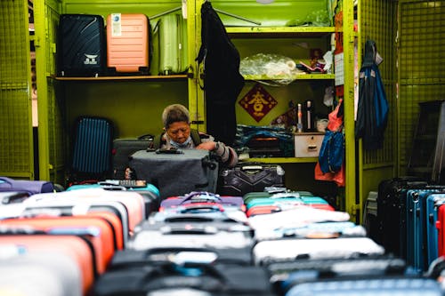 Woman Selling Suitcases in a Shop 