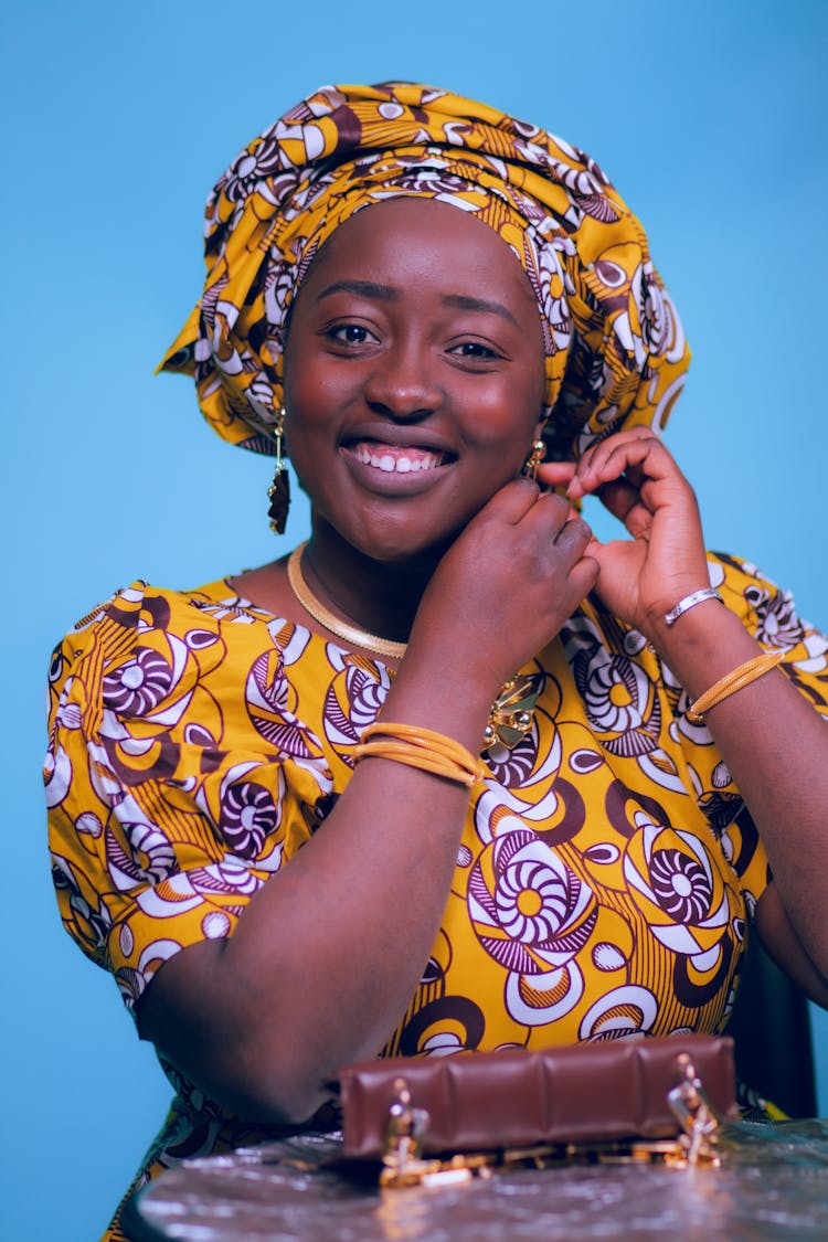 Smiling Woman Adjusting An Earring