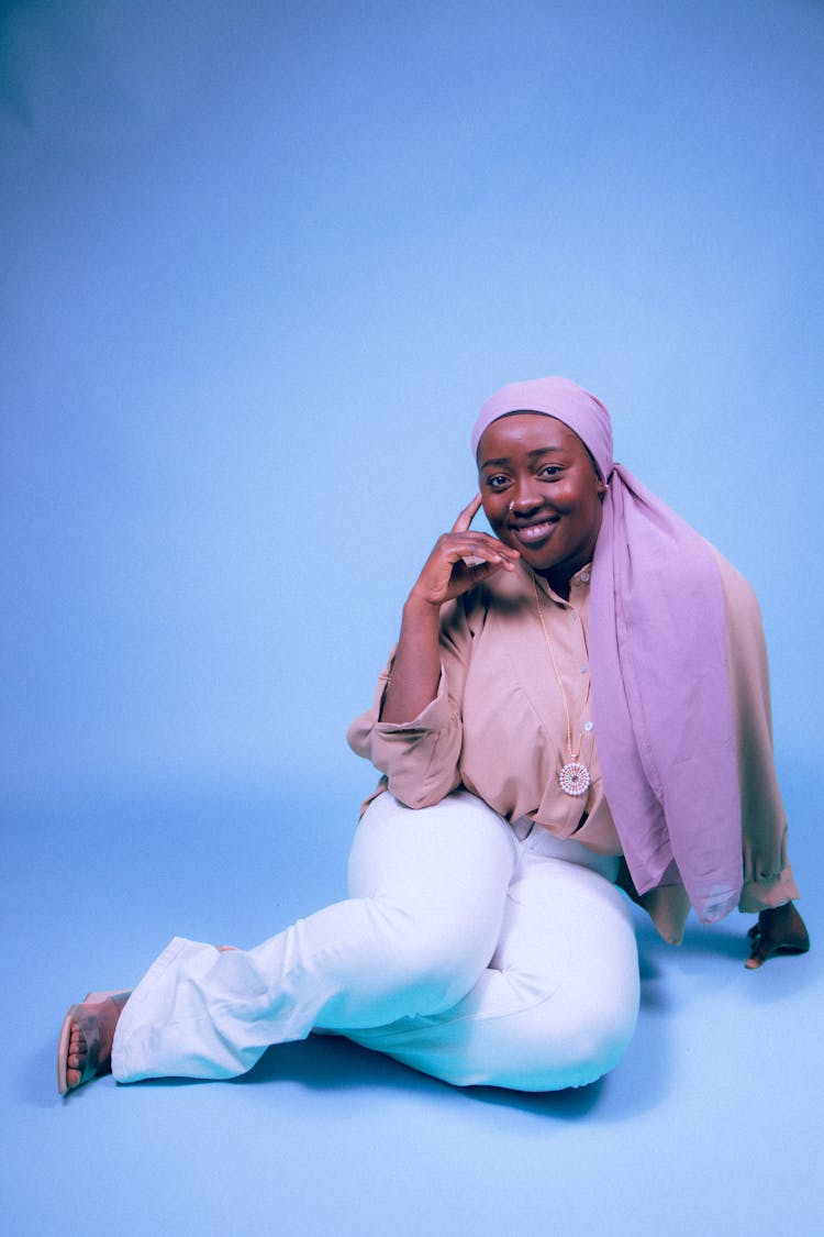 Smiling Woman Sitting In A Studio 