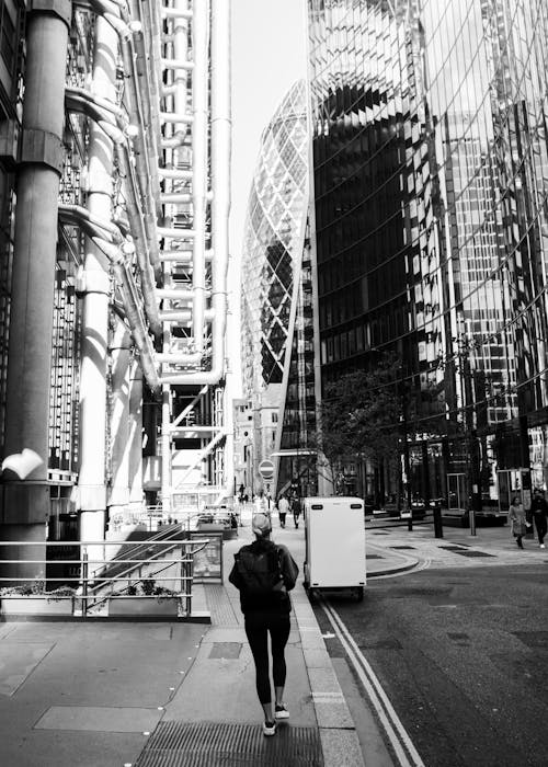 Back View of a Woman Walking on a Sidewalk in Downtown London, England, UK 