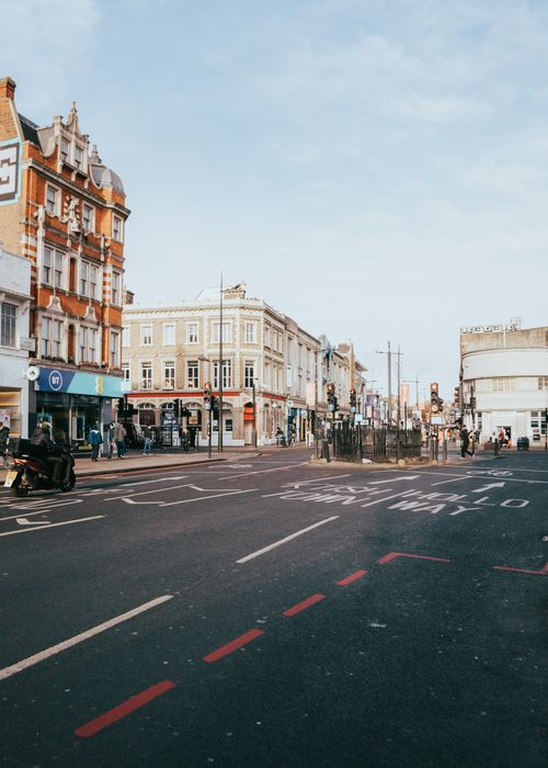 Free Vibrant Camden street scene with historic architecture and passing traffic in London. Stock Photo