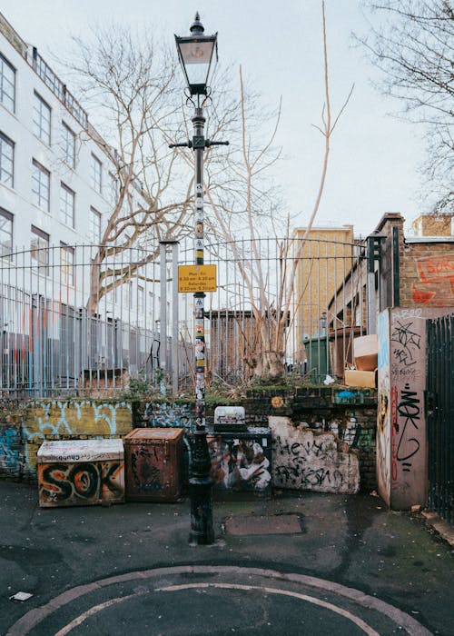 Graffiti on the Wall with a Fence in City 