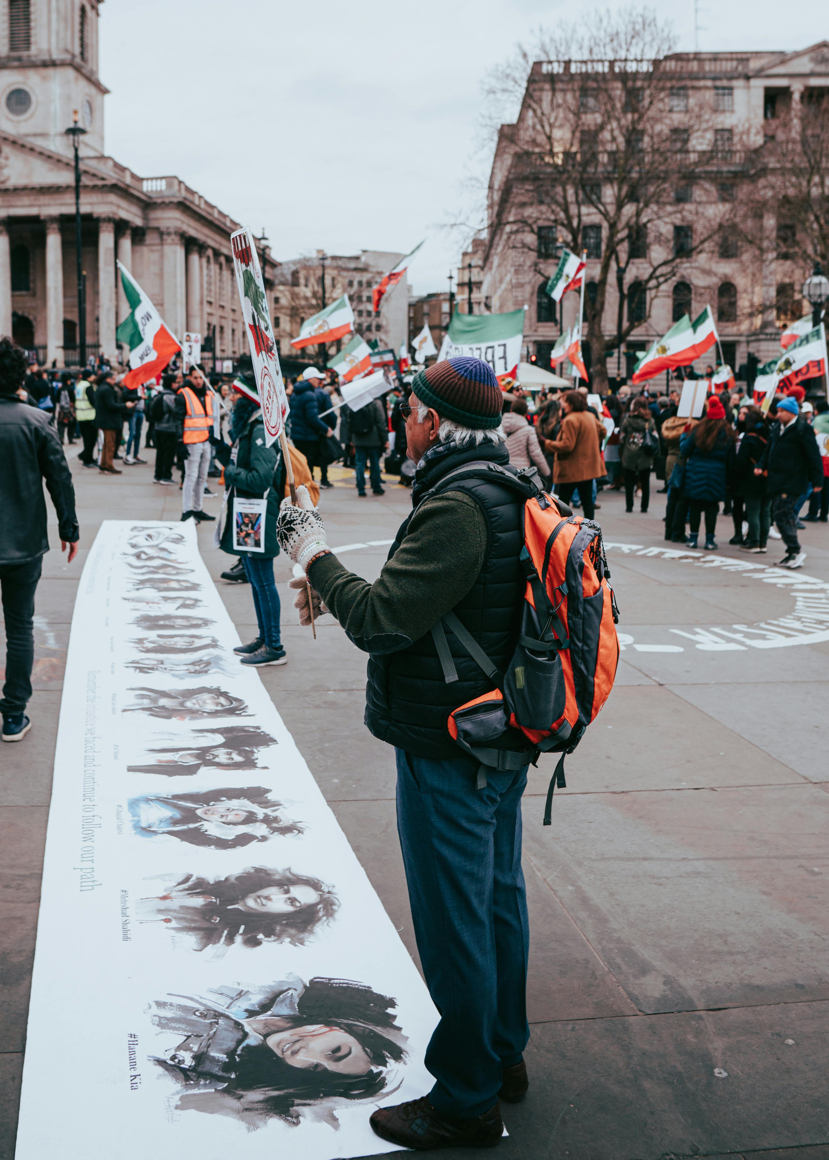 irani man with a sign at a london protest