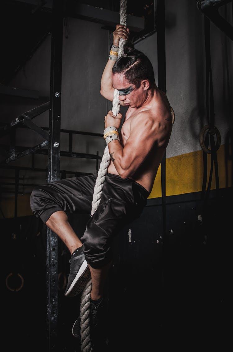 Man Climbing A Rope