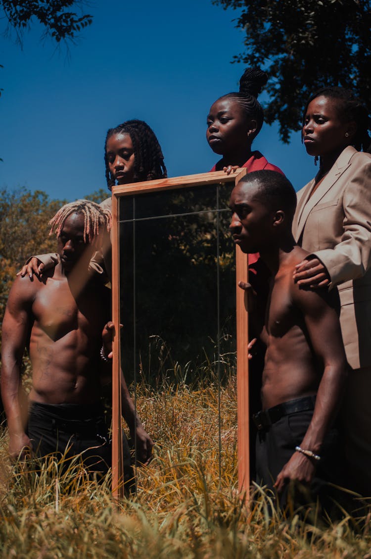 Group Of People Holding A Mirror 