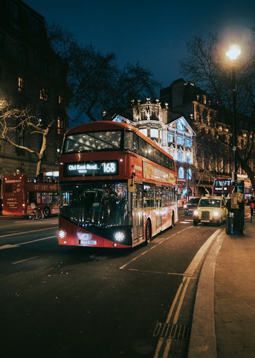 Double Decker Bus Driving Through London at Night