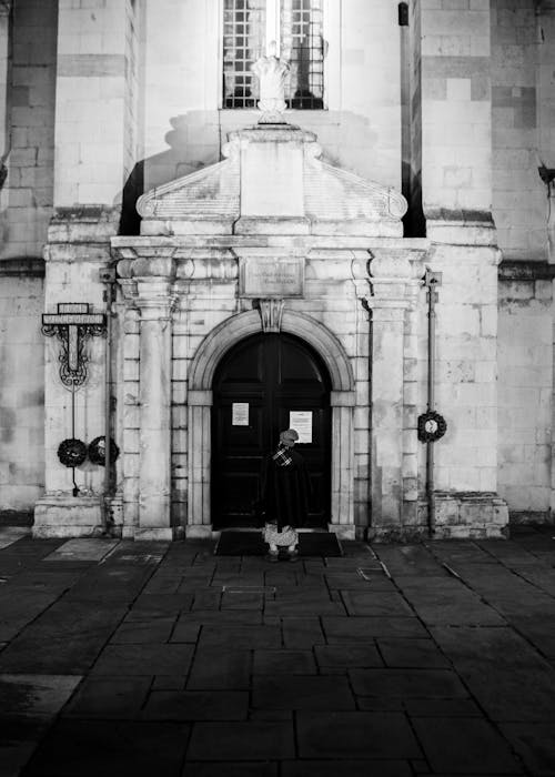 Woman Standing Outside the Entrance to a Church in London