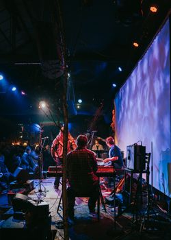 A vibrant live music performance in a London venue, capturing the energy and atmosphere of a night concert.