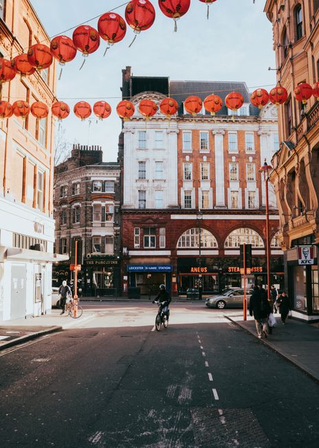 Vibrant street in London Chinatown with red lanterns and urban architecture.