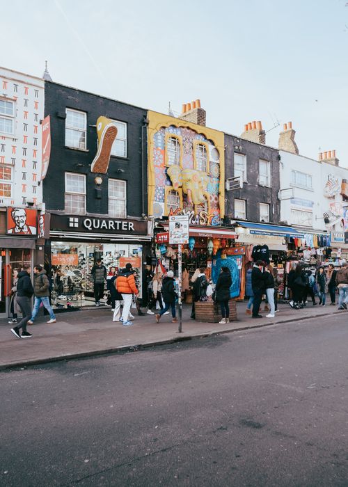 Free Vibrant street scene in Camden Market, London, capturing diverse shops and bustling pedestrians. Stock Photo