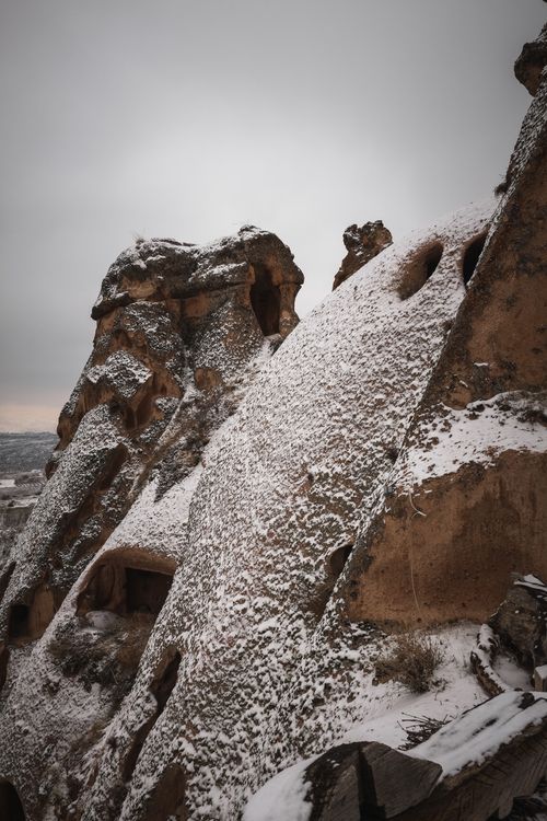 Free Captivating snow-covered rock formations in Cappadocia, Turkey during winter. Stock Photo