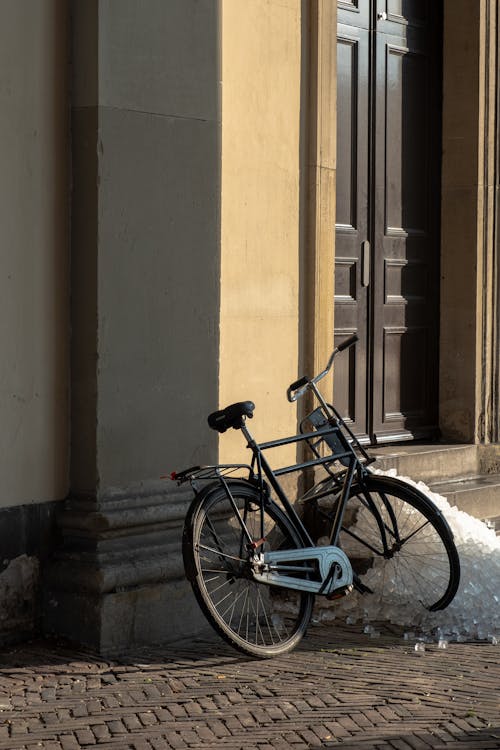 A Bicycle Leaning on a Building Exterior 