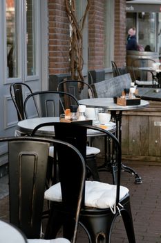 Inviting outdoor cafe seating with stylish chairs and tables, perfect for a relaxed atmosphere.