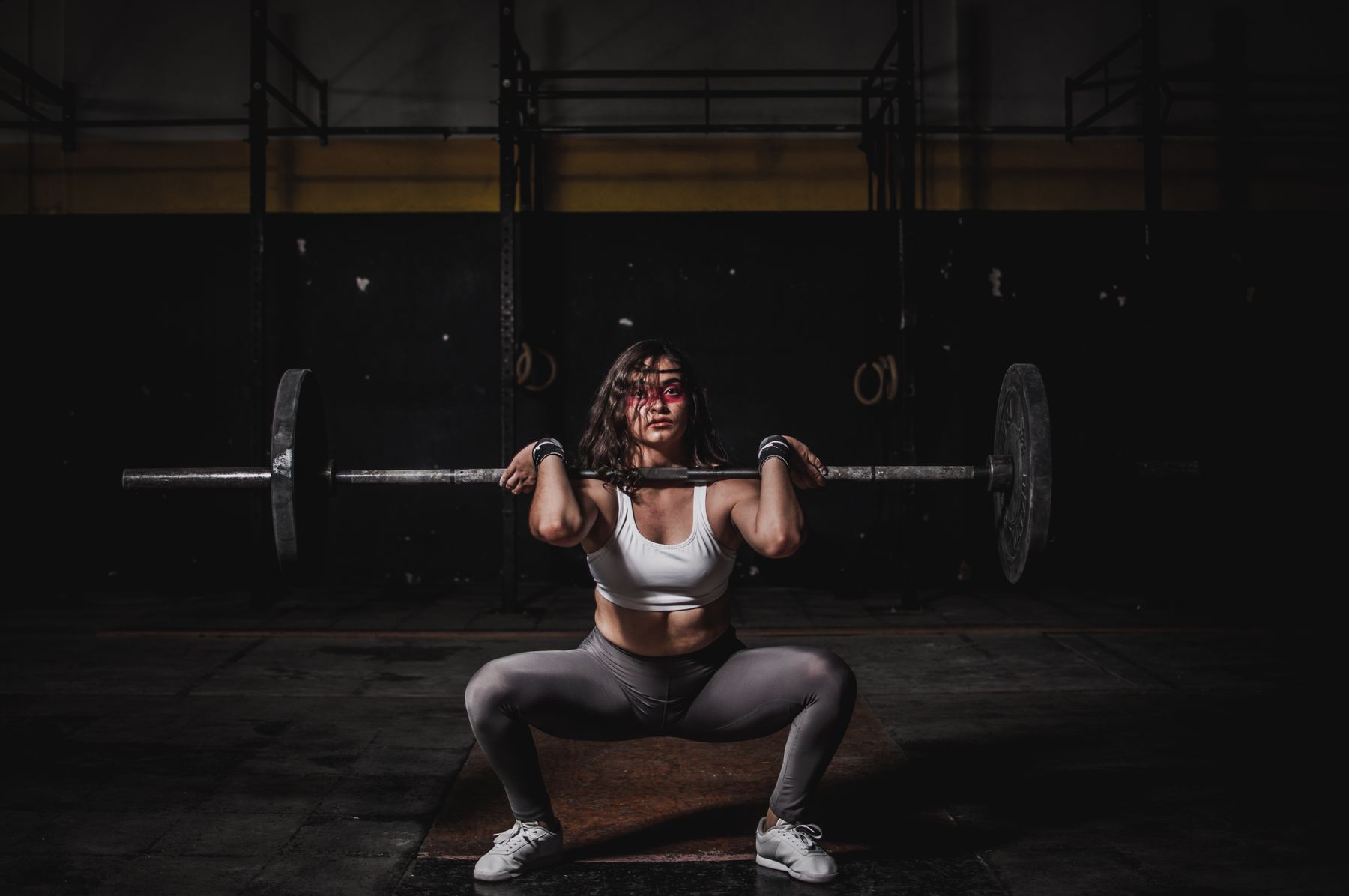 Athlete training with strength equipment in a refined gym environment