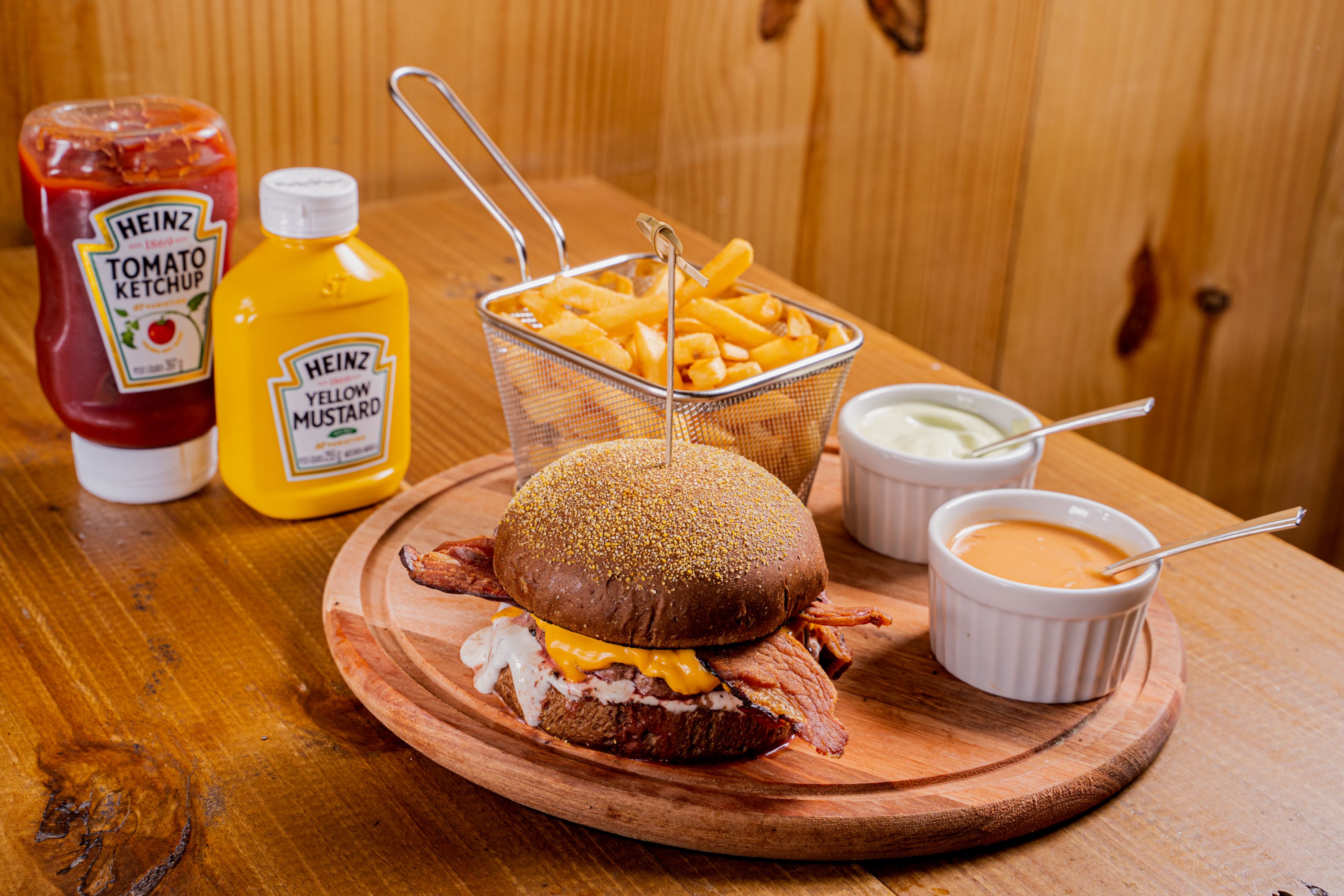 Close-up of a smash burger topped with sauce and crispy patties