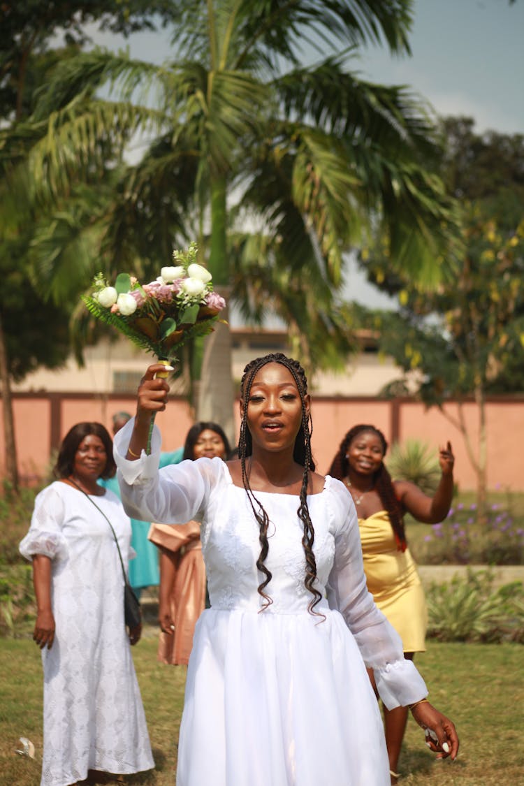 Woman Throwing A Wedding Bouquet