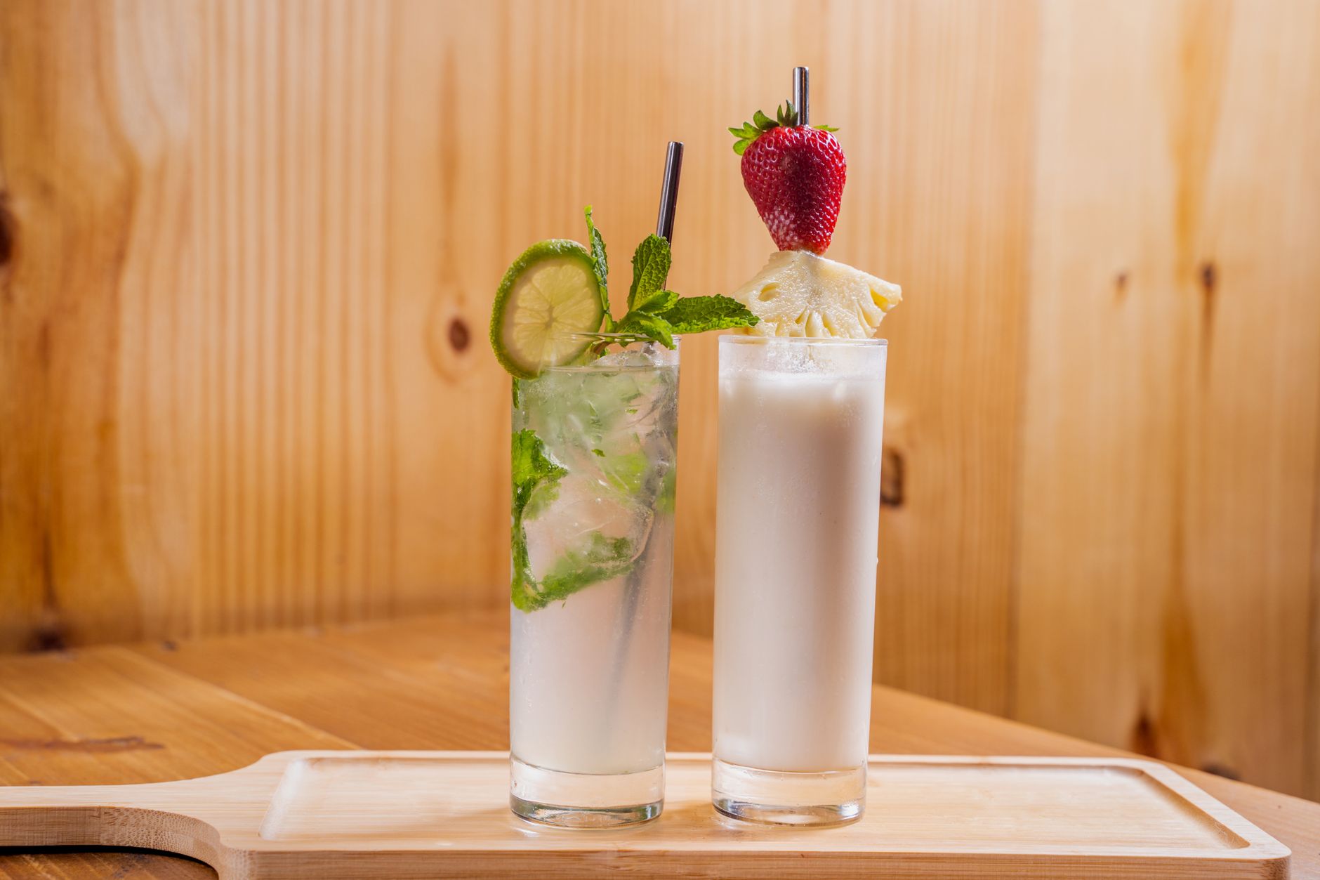 Beer Colada with tropical fruit garnish on wooden table