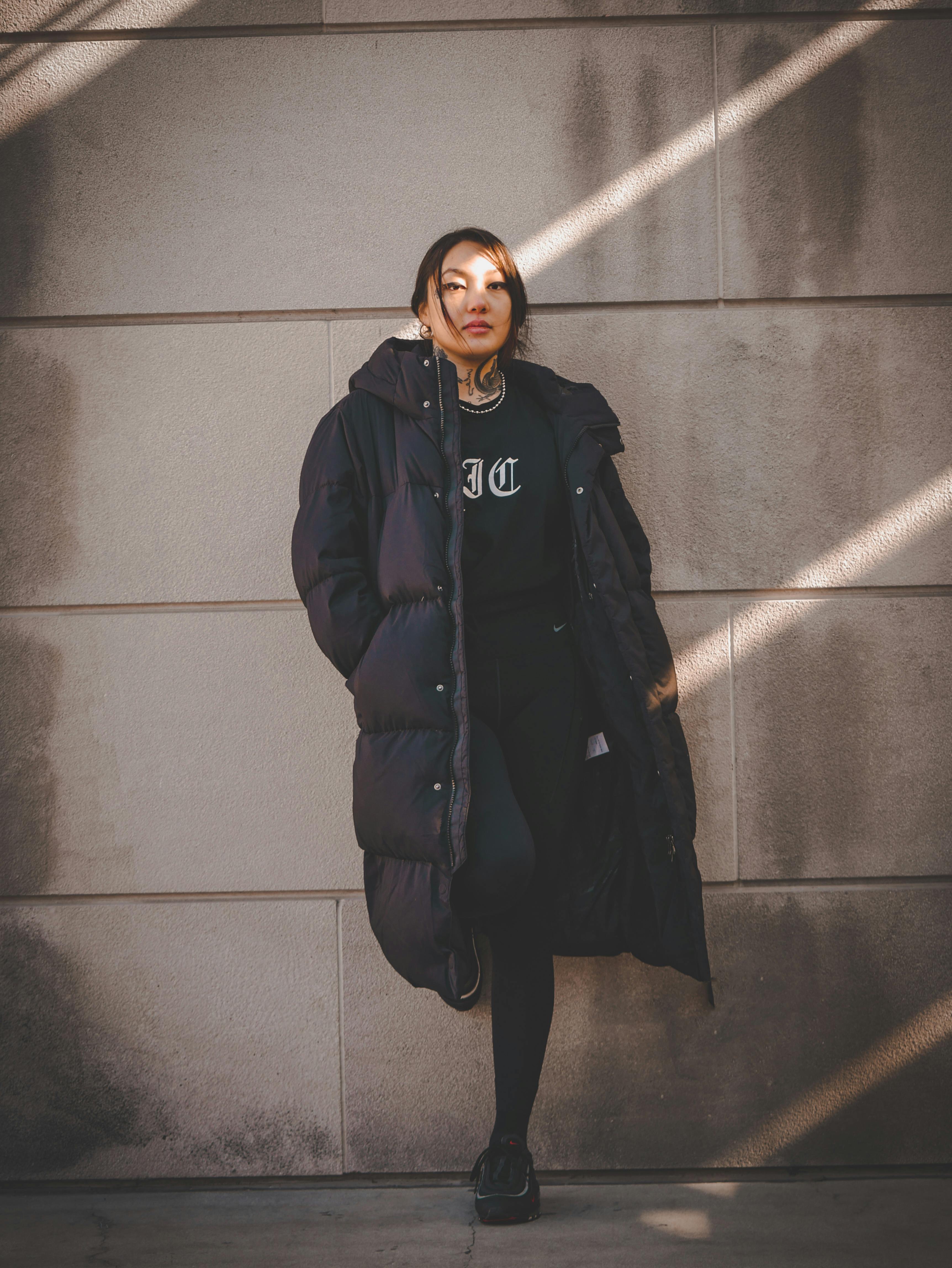 Woman in black clothing wearing a puffer coat