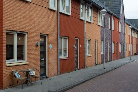 A picturesque view of a suburban street lined with colorful row houses exhibiting a unique architectural charm.