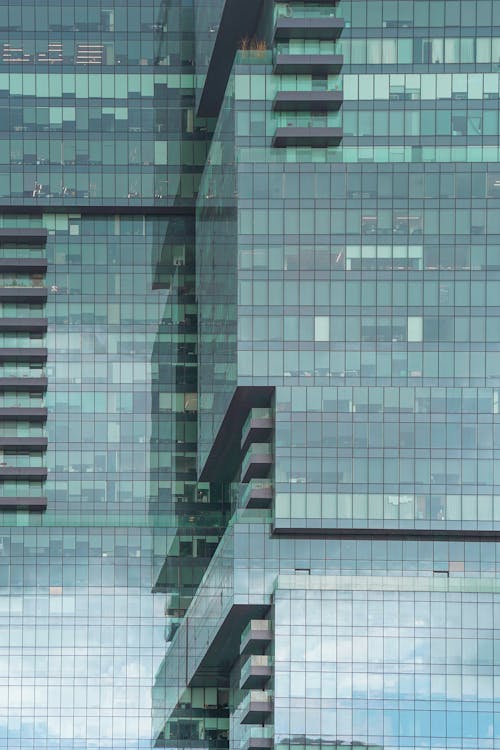 Glass green square Windows of facade modern city business building skyscraper