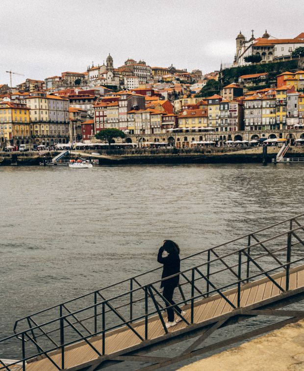 Historic riverside rooftops seen from a bridge in Porto, Portugal — photo by Anna Panchenko on Pexels