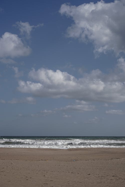 Free Waves Flowing on the Beach Stock Photo