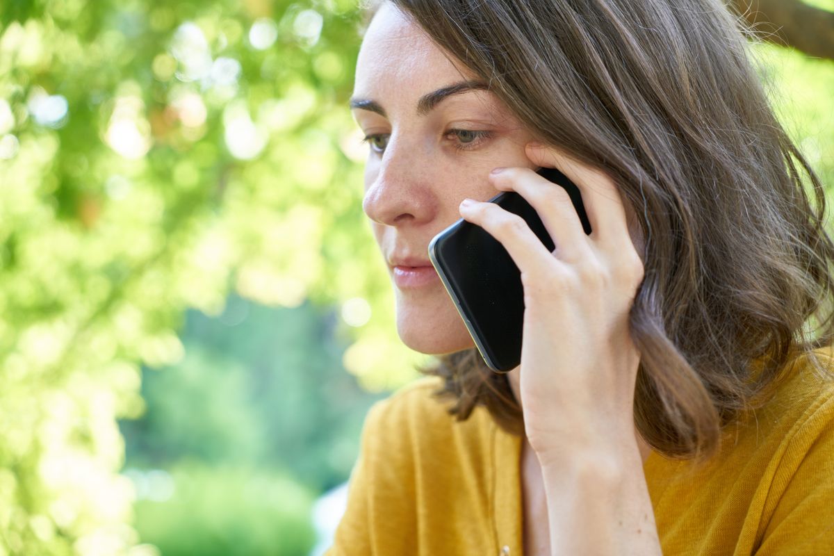 A woman on a phone call seeking help
