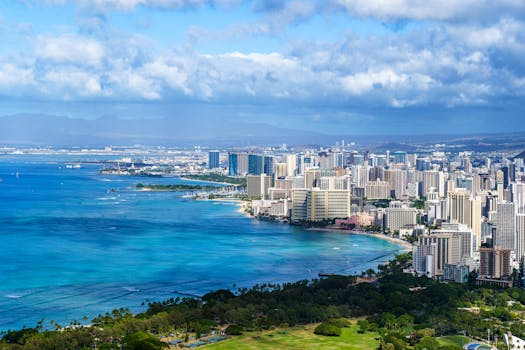 Photo by Cyrill Stunning aerial view of Honolulu's skyline along the Pacific Ocean on a sunny day.