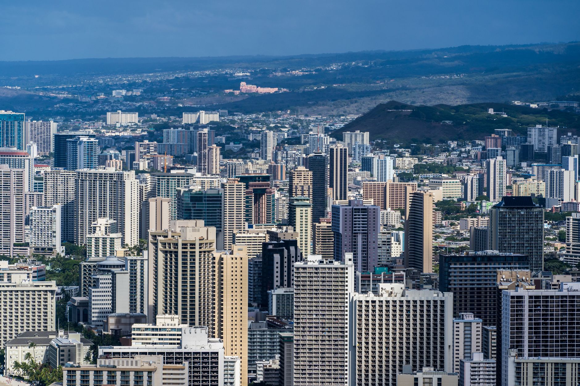 Photo by Cyrill Aerial view of Honolulu's modern skyline with skyscrapers under clear blue skies.