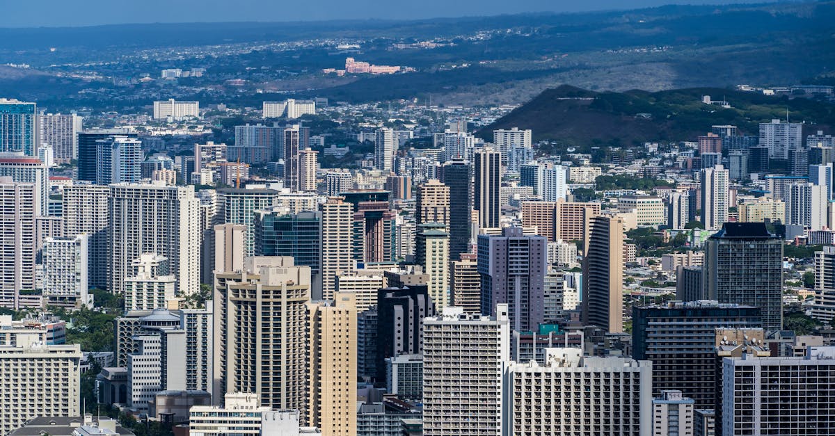 Aerial view of Honolulu's modern skyline with skyscrapers under clear blue skies.