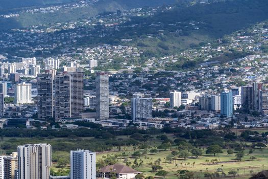 Photo by Cyrill Stunning aerial view of Honolulu's skyline with lush mountains in the background.