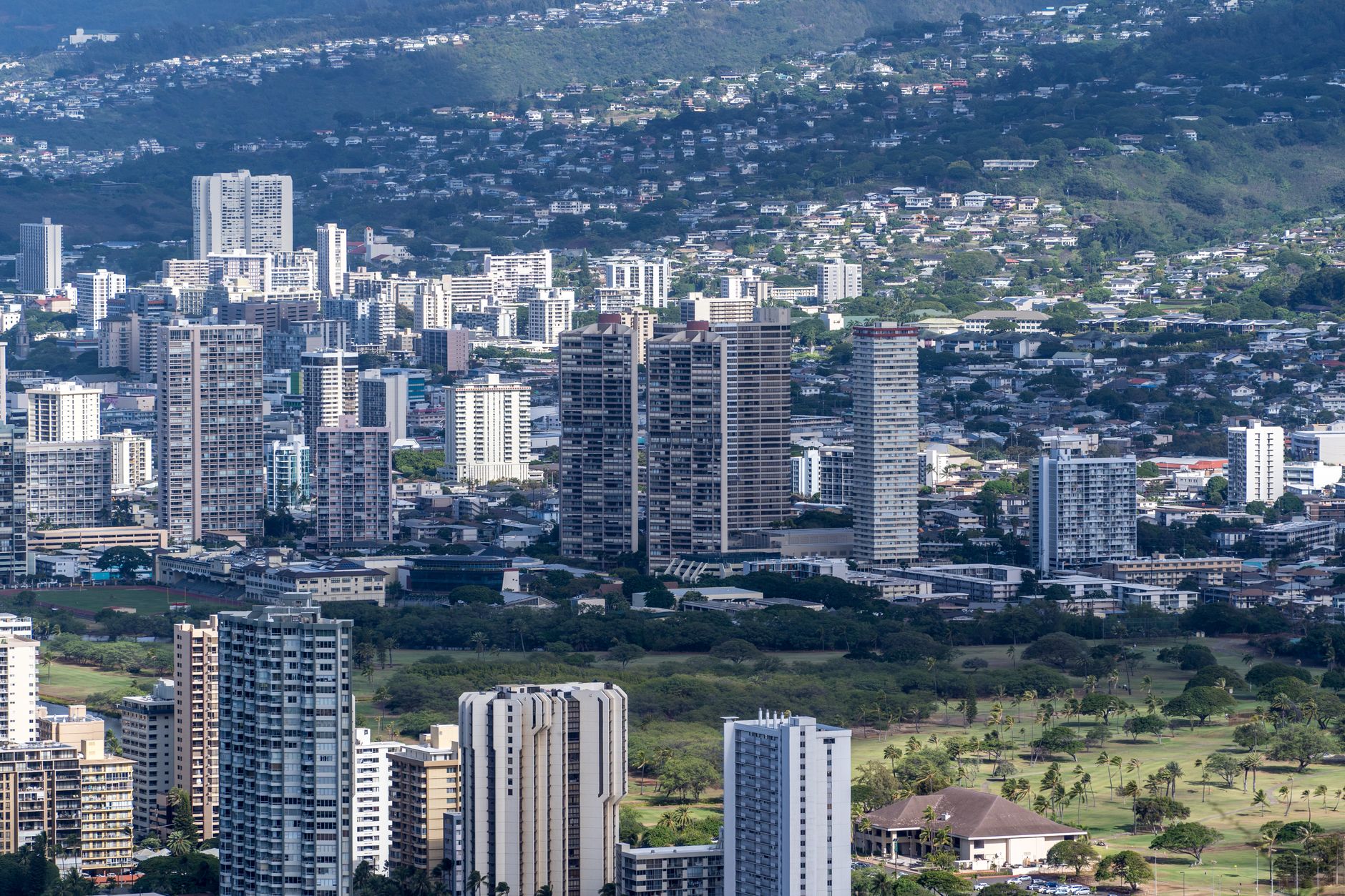 Photo by Cyrill Stunning aerial shot showcasing Honolulu's modern skyline and surrounding greenery.