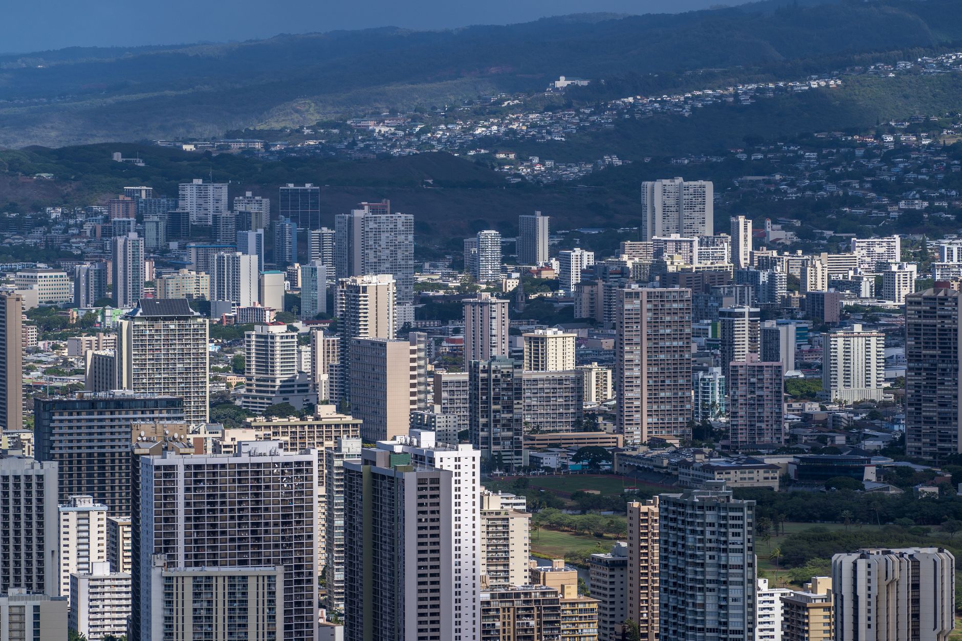 Stunning aerial view of Honolulu's urban skyline featuring modern skyscrapers under a clear sky.