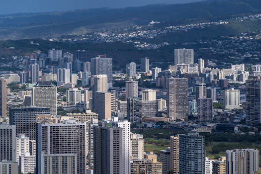 Photo by Cyrill Stunning aerial view of Honolulu's urban skyline featuring modern skyscrapers under a clear sky.